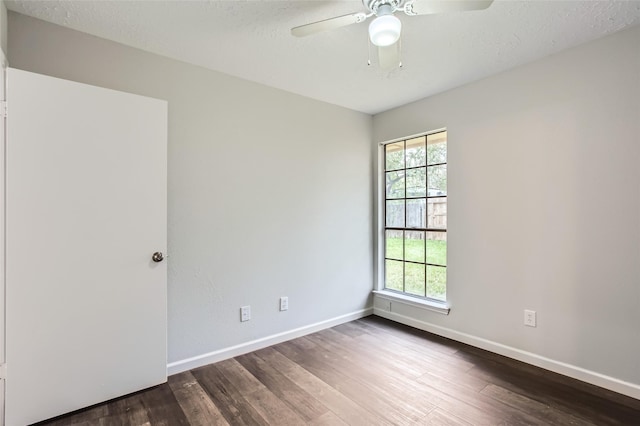 unfurnished room featuring ceiling fan, a textured ceiling, and dark hardwood / wood-style flooring