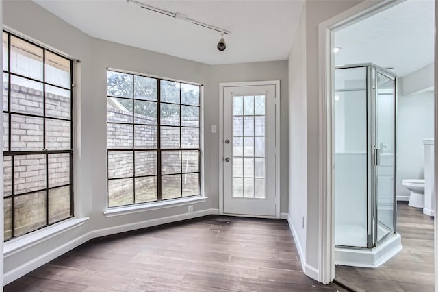 doorway featuring hardwood / wood-style flooring and track lighting