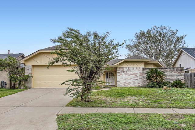 view of front of property featuring a garage and a front lawn