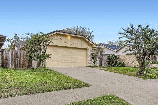 single story home featuring a garage and a front lawn