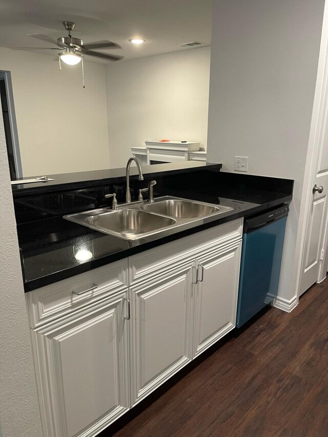 kitchen with ceiling fan, sink, dark wood-type flooring, stainless steel dishwasher, and white cabinets