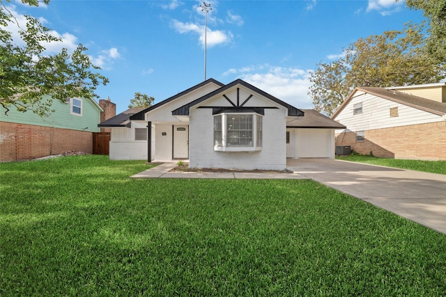 view of front of home with a front lawn and central air condition unit