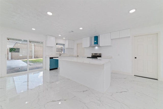 kitchen featuring white cabinets, a kitchen island, wall chimney range hood, and stainless steel appliances