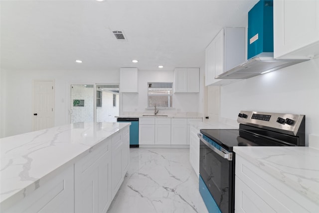 kitchen featuring white cabinets, sink, stainless steel appliances, and wall chimney range hood