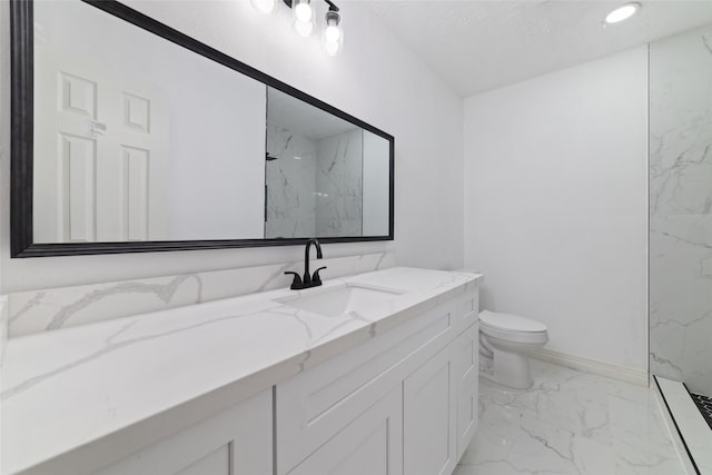 bathroom with toilet, a tile shower, and vanity