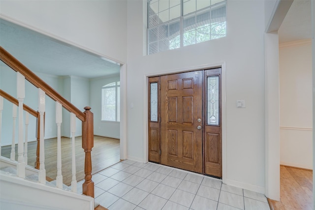 foyer with light hardwood / wood-style floors and a high ceiling