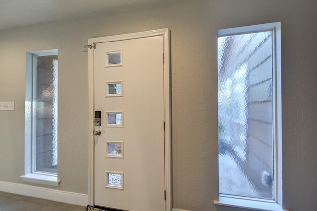 entryway featuring light tile patterned flooring