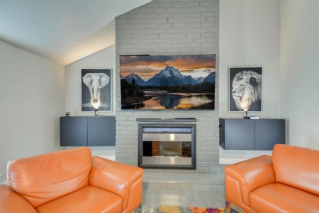 living room featuring lofted ceiling and a fireplace