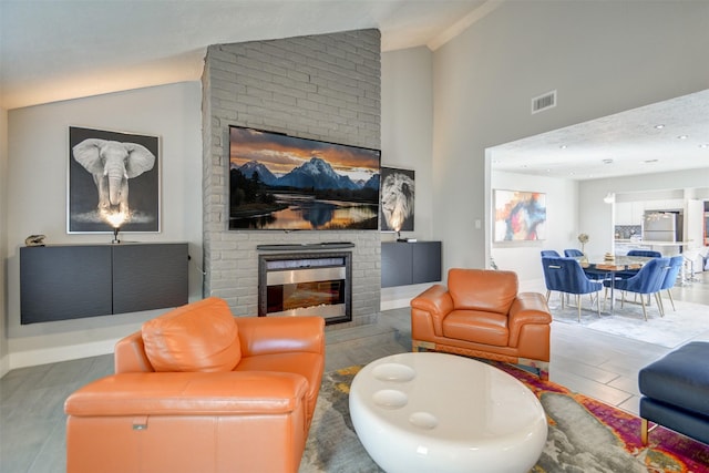 living room with lofted ceiling and a fireplace