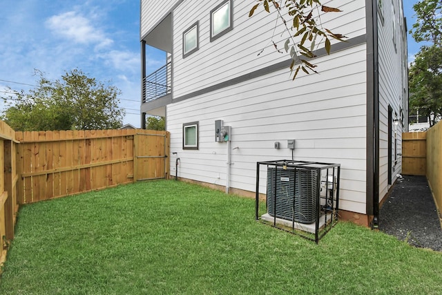 exterior space featuring a lawn and central AC