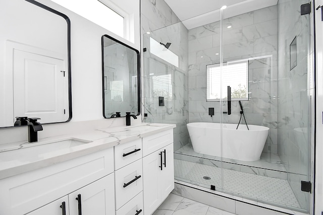 bathroom with vanity and shower with separate bathtub