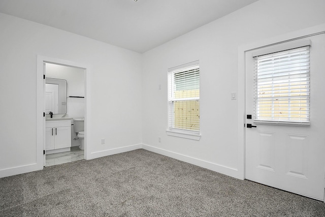 doorway to outside with carpet flooring and sink