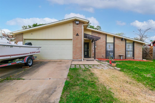 single story home featuring a garage and a front lawn