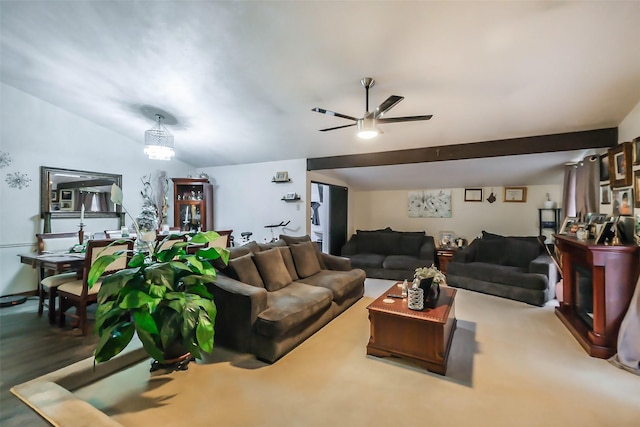 carpeted living room with ceiling fan with notable chandelier and lofted ceiling