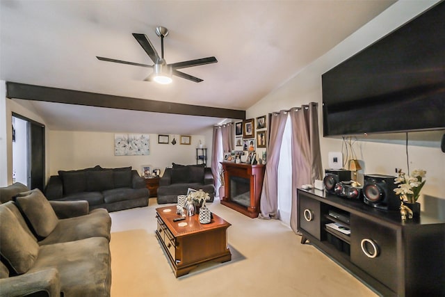 carpeted living room with ceiling fan and lofted ceiling