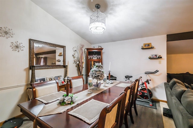 carpeted dining space with a chandelier and lofted ceiling