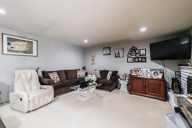 living room with a fireplace and carpet