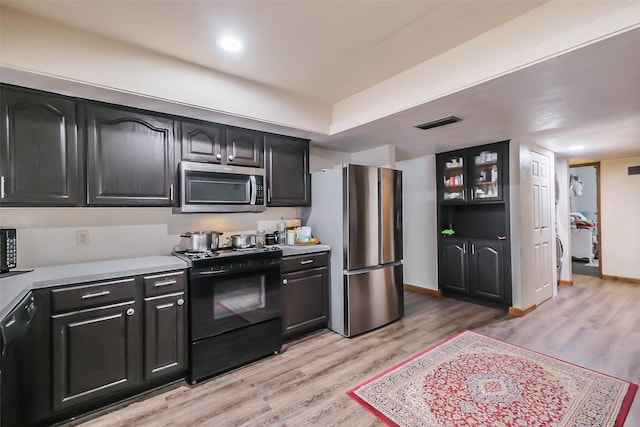 kitchen featuring light hardwood / wood-style flooring and black appliances