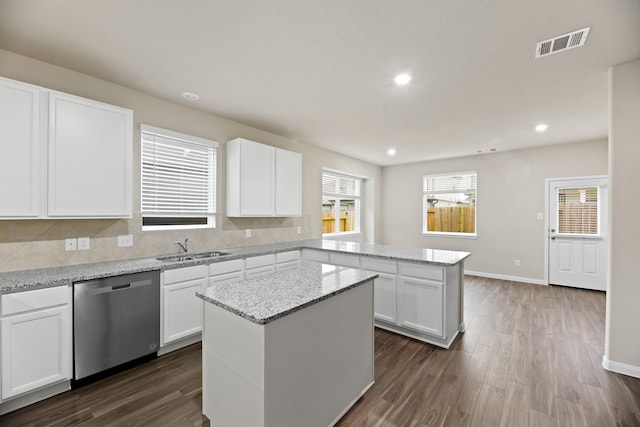 kitchen featuring dishwasher, a center island, white cabinetry, and sink