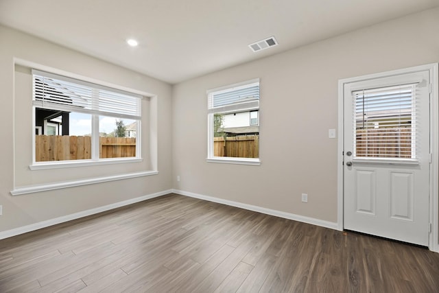 interior space with plenty of natural light and dark wood-type flooring