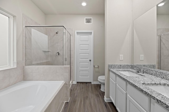 full bathroom with hardwood / wood-style floors, vanity, toilet, and shower with separate bathtub