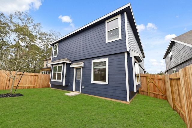 rear view of property featuring a yard