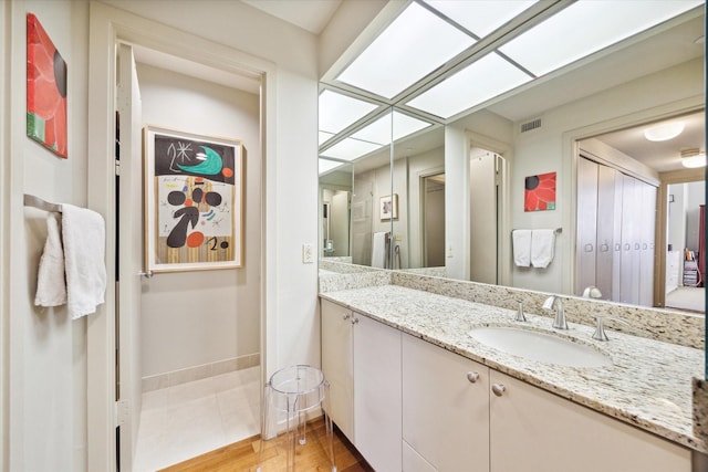 bathroom with vanity and hardwood / wood-style flooring