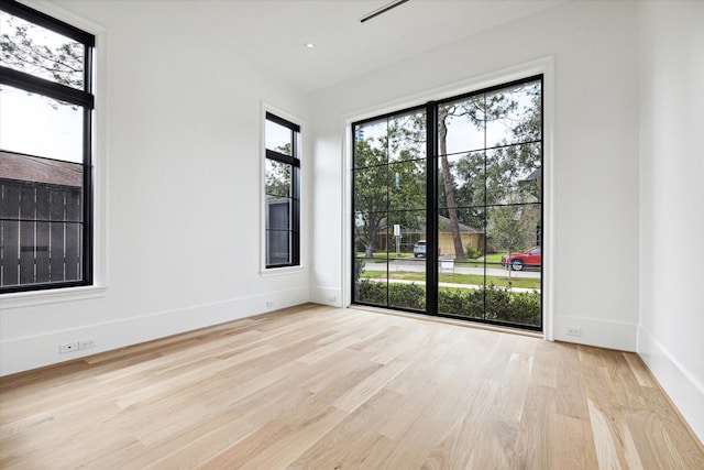 unfurnished room with light hardwood / wood-style floors