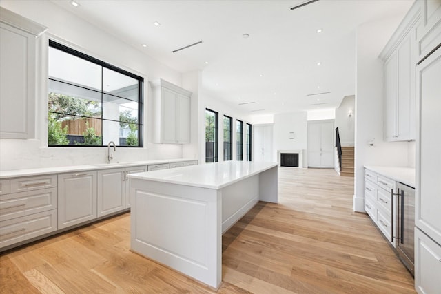 kitchen with plenty of natural light, light wood-type flooring, and white cabinetry