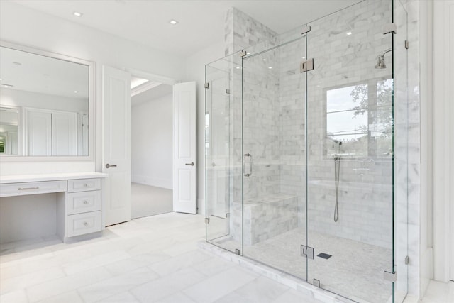 bathroom featuring vanity and a shower with shower door