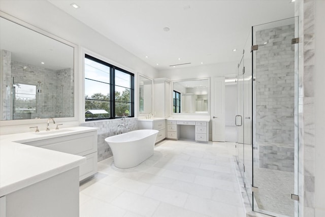 bathroom featuring vanity, shower with separate bathtub, and tile walls