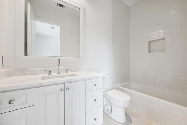 full bathroom with tile patterned flooring, vanity, toilet, and tiled shower / bath combo