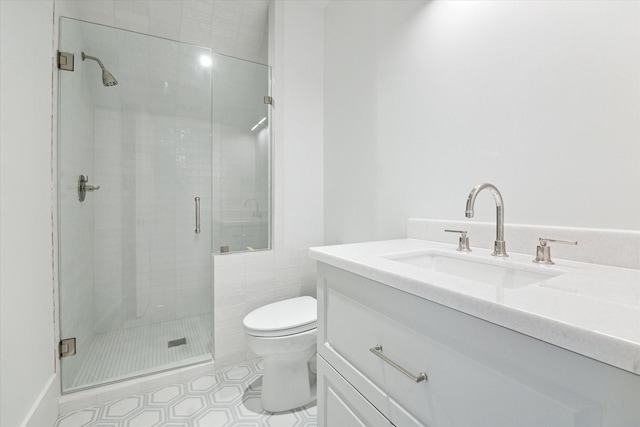 bathroom featuring vanity, toilet, and walk in shower