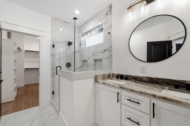 bathroom featuring vanity and a shower with shower door