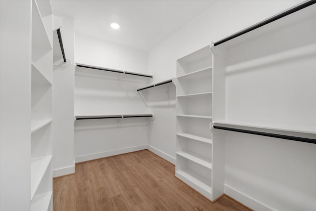 walk in closet with light wood-type flooring