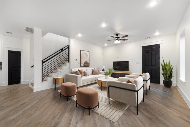 living room with visible vents, recessed lighting, stairway, and light wood-style floors