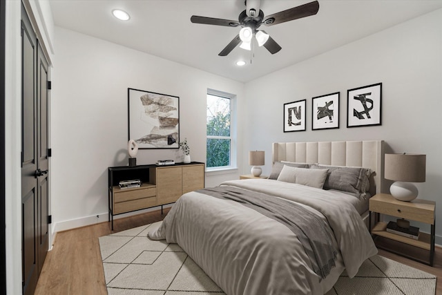 bedroom featuring ceiling fan and light hardwood / wood-style flooring