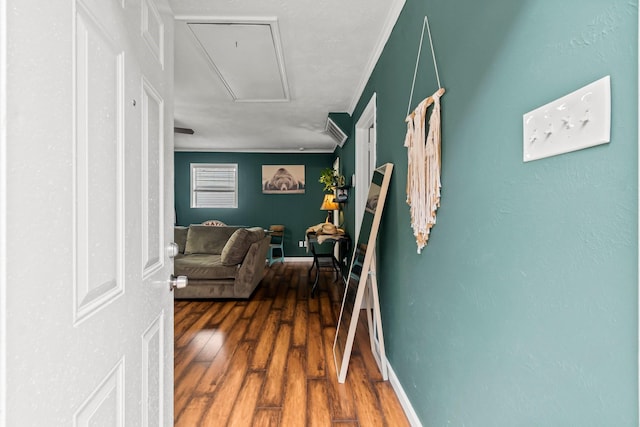 hall featuring crown molding and hardwood / wood-style floors