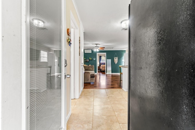 corridor featuring light hardwood / wood-style floors and ornamental molding