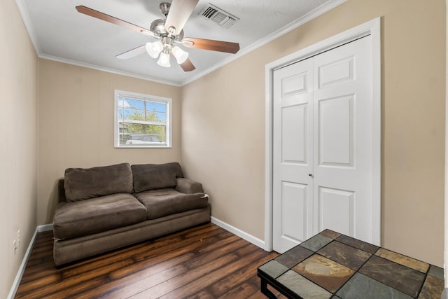 living room featuring ceiling fan, dark wood-type flooring, and ornamental molding