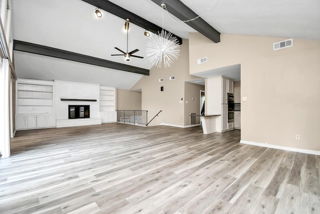 unfurnished living room featuring beamed ceiling, light wood-type flooring, high vaulted ceiling, and ceiling fan with notable chandelier