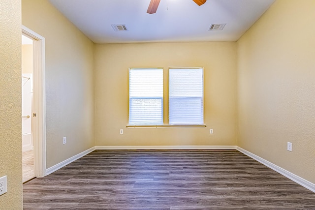 spare room featuring dark hardwood / wood-style floors and ceiling fan