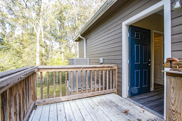 wooden terrace featuring cooling unit