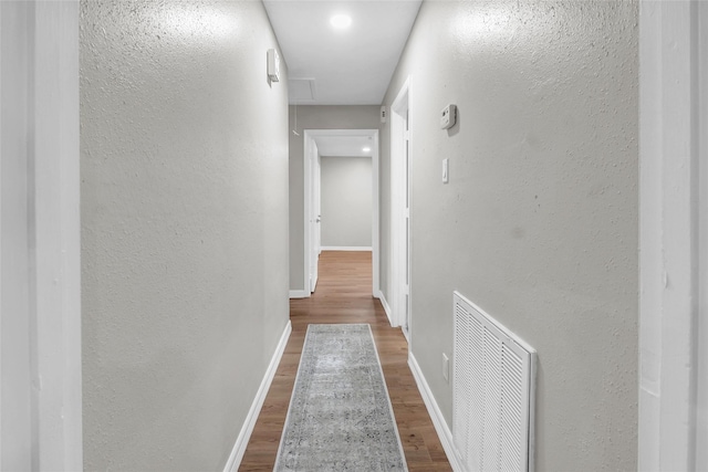 hall with hardwood / wood-style floors