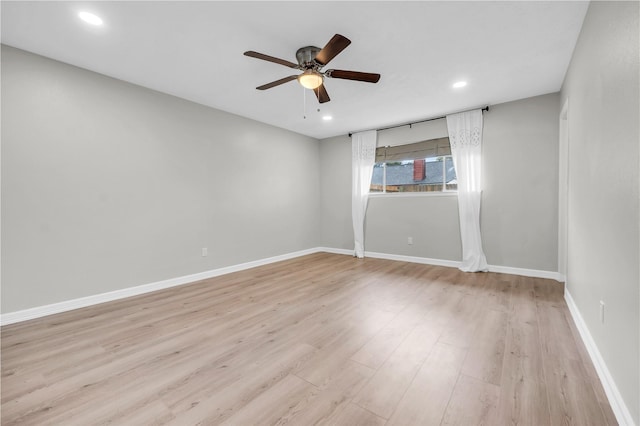 spare room with light hardwood / wood-style flooring and ceiling fan