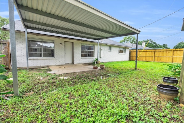 rear view of house with a yard