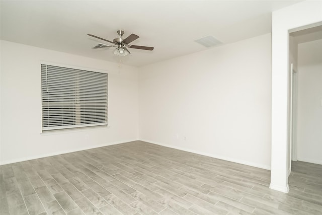 spare room with light wood-type flooring and ceiling fan