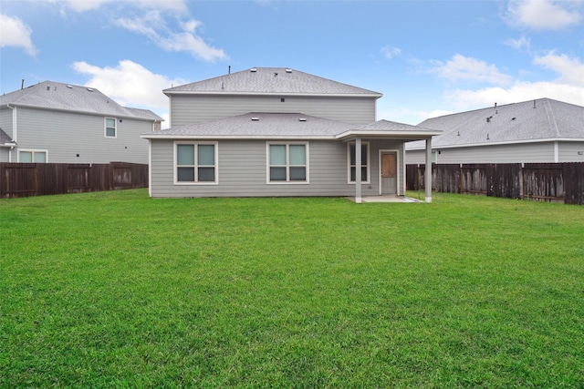 back of property featuring a patio area and a yard