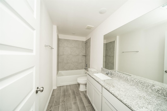 full bathroom featuring wood-type flooring, vanity, toilet, and tiled shower / bath