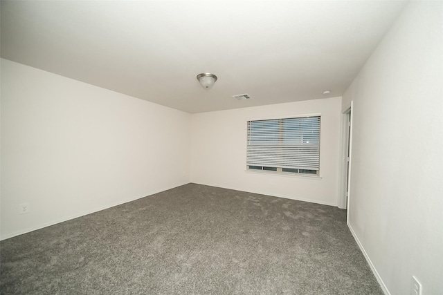 empty room featuring dark carpet